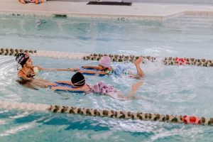 Photo of kids taking swimming lessons