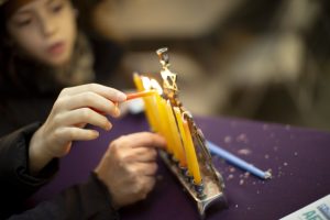 Kids lighting the Menorah at the 14Y